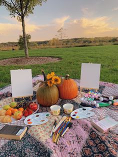 the table is covered with art supplies and pumpkins