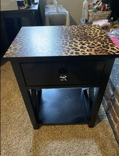 a black table with a leopard print top