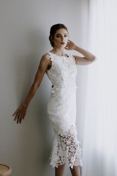 * Ivory Guipure Lace * Square Neckline * Deep V back * Midi Length * Black Satin Bow adornment in back * Zipper closure * Floating Lace pieces * Fully Lined Size Chart: *Bust: 32-34 inches *Waist: 25-26 inches *Hips: 35-36 inches White Sleeveless Gown For Ceremony, Elegant Wedding Gown With Back Opening, Fitted Bodice Evening Dress With Back Opening For Wedding, Wedding Evening Dress With Back Opening And Fitted Bodice, Elegant Evening Dress With Sheer Back For Wedding, Floor-length Wedding Dress With Lace Back, Wedding Evening Dress With Sheer Back And Fitted Bodice, Wedding Gown With Lace Back And Floor-length, White Dresses With Fitted Bodice For Reception