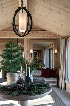 a living room filled with furniture and a christmas tree on top of a round table