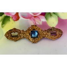 Stunning antique brass gilt bar pin brooch from the 1920s, featuring a magnificent blue glass tone. The piece is a testament to the craftsmanship of the era, perfect for collectors and vintage enthusiasts alike. It measures 2.5" long. The brass is aged but otherwise in good wearable condition.  * Beautiful 1920s antique brooch * Crafted from brass gilt  * Features a striking blue glass tone * Ideal for vintage jewelry collectors * Offers a unique touch to any outfit Size: Womens 2.5" Condition: Pre-Owned Good Blue Art Deco Formal Brooch, Art Deco Blue Brooches As Gifts, Art Deco Blue Brooches For Gifts, Blue Victorian Brooches For Formal Occasions, Victorian Blue Brooch For Formal Occasions, Blue Victorian Brooch For Formal Occasions, Antique Blue Collectible Brooches, Antique Brooches, The 1920s