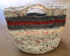 a bag made out of knitted material sitting on the floor