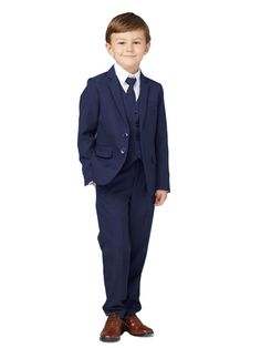 a young boy in a suit and tie posing for the camera with his hands in his pockets