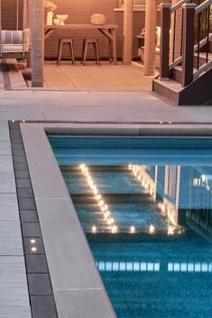 an empty swimming pool with some lights on it