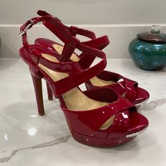 Absolutely Gorgeous Red Leather Platform Stiletto Heels By Gianni Bini, Size 7m. Features Crossover Red Leather Straps At Ankle, And Crossover Red Leather Straps At Toebox. Peep-Toe With Silver-Toned Metal Accent At Tod Front. Two Tiny Scuffs To Backs Of The Heels, One Tiny Scratch To Metal On Left Shoe; Otherwise These Shoes Look Practically Unworn. Please Refer To Photos. The Heel Measures Approximately 4.75”Tall. The Platform Is Almost 1” Tall At Its Highest Point. Platform Stiletto Heels, Gianni Bini Shoes, Platform Stilettos, Fashion High Heels, Gianni Bini, Metallic Accents, Heel Sandals, High Heel Sandals, Red Leather