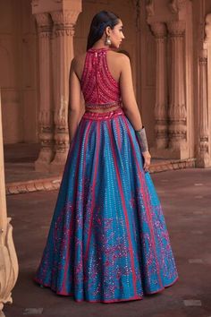 Teal blue and pink flared kalidar lehenga with all over gleaming orchid garden embroidery using cutdana, sequin, beads highlights and comes with a separate cancan. Paired with a cut out detail halter neck padded blouse with floret sequin, beads, cutdana encrustments, dangling glass beads on the hem and lace border embellished dupatta. - Aza Fashions Blue Sleeveless Lehenga For Navratri, Sleeveless Blue Traditional Wedding Wear, Blue Sleeveless Wedding Traditional Wear, Sleeveless Blue Wedding Traditional Wear, Sleeveless Blue Choli For Wedding, Blue Sleeveless Lehenga For Diwali, Blue Sleeveless Choli For Navratri, Sleeveless Blue Choli For Navratri, Blue Sleeveless Choli With Pallu