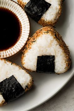 Three Salmon onigiri on a plate with a side of soy sauce and yuzu Onigiri Photography, Meat Onigiri, Onigiri Aesthetic, Salted Salmon, Sushi Aesthetic