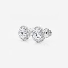 Enhance your everyday studs with these halo diamond stud earings. Each large round lab grown diamond is encircled with enchanting smaller diamonds to create a halo effect. White Gold Round Cluster Earrings With Halo, White Round Halo Cluster Earrings, Formal Round Halo Cluster Earrings, White Round Cluster Earrings With Halo, Diamond White Halo Setting Lab Grown Diamond Earrings, Classic Halo Cluster Earrings In Diamond White, Classic Diamond White Cluster Earrings With Halo, Diamond White Halo Setting Lab-grown Diamond Earrings, Classic Round Diamond Earrings With Halo