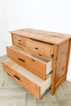 a wooden dresser with three drawers on top