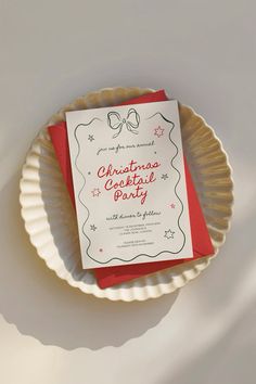 a red and white christmas party card on a paper plate