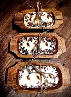 three wooden trays filled with food on top of a wooden table next to each other