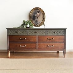 an old dresser with a portrait on top