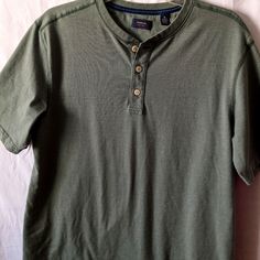 Two Men's Size Medium Button Collar T-Shirt. One Is Sage Green The Other Is Grey. Both Never Worn. Casual Cotton T-shirt With Placket, Casual Button-up T-shirt, Casual Cotton Shirt With Henley Neckline, Casual Cotton Henley With Buttons, Summer Short Sleeve Henley With Buttons, Cotton Crew Neck Shirt With Button Closure, Cotton Henley Shirt With Buttons, Casual Cotton Henley Shirt, Cotton Henley Neckline Shirt With Buttons