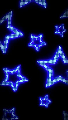 some blue and white stars that are on a black surface with light up letters in the middle