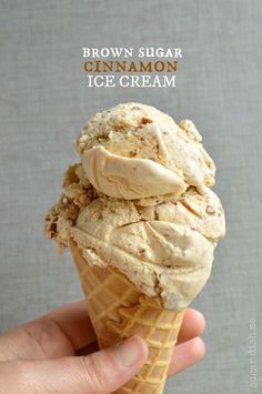 a hand holding an ice cream cone filled with brown sugar cinnamon ice cream