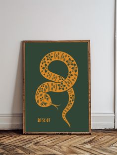 a green and yellow poster with a snake on it's side in an empty room