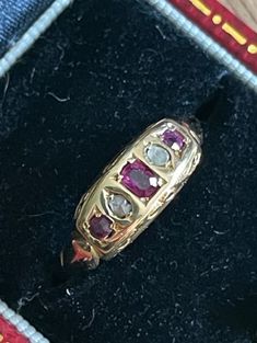 Lovely 18k gold Natural & Genuine Ruby & Diamond ring  The ring is approximately a size 6 but can be easily sized.  Classic in design with side detailing (a bit worn- see photos) Many hallmarks on the inside...see photos. Hallmarks indicate Birmingham 1907 Hallmarked 18=18k gold...tested as such The center ruby measures approximately 3.5x 2.75mm  2 side rubies: 2.5mm There are a total of 2 diamonds somewhat crudely cut approx. 2.25 mm each for accents The rubies are a beautiful fuschia red color Victorian Multi-stone Yellow Gold Rings, Victorian Multi-stone Yellow Gold Diamond Ring, Victorian Yellow Gold Birthstone Ring, Victorian Yellow Gold Birthstone Ring With Gemstone, Victorian Style Yellow Gold Birthstone Ring, Victorian Yellow Gold Diamond Ring With Gemstone, Victorian Ruby Rings In Yellow Gold, Victorian Yellow Gold Rings With Ruby, Victorian Ruby Ring In Yellow Gold