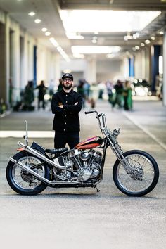 a man standing next to a parked motorcycle