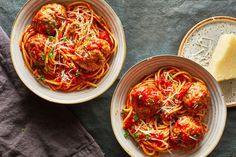 two bowls filled with spaghetti and meatballs