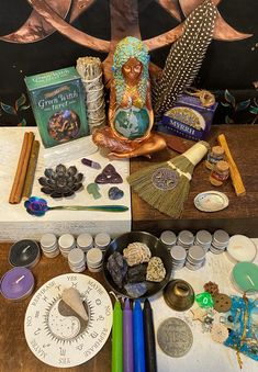 an assortment of crafting supplies sitting on a table next to a painting and other items