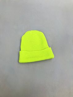 "Bright Neon  Acid yellow/green knitted Beanie  One size fits all.  This is a vintage Army surplus item but is brand new and never been worn. Made from 100% Acrylic  Lovely and soft material, lasts forever  These hats are great when walking in the dark. You can spot your friend from miles away with one of these on.  Size  when laid flat (as in the picture with one fold) approximately 9\" x 8\" This hat can be worn in so many different ways  Glows like a treat under UV lights  Makes a great stock Cheap Yellow Crochet Beanie, Canvas Rucksack Backpack, Canvas Rucksack, Army Surplus, Knit Beanie Hat, Unisex Gifts, Skull Cap Beanie, Green Cotton, Skull Cap