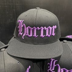 "HORROR HAT Black Snapback Hat Purple Embroidery On Black Hat BLACK Under-Bill 80% Acrylic / 20% Wool Suggested Size Range: Fits hat sizes: 7 - 7 3/4 (22\"-24.25\")" Black Embroidered Flat Bill Fitted Hat, Purple Curved Brim Baseball Cap For Streetwear, Purple Curved Brim Hat For Streetwear, Purple Baseball Cap For Streetwear, Embroidered Snapback Fitted Hat For Streetwear, Purple Snapback Baseball Cap, Purple Snapback Cap For Streetwear, Purple Snapback Hat For Streetwear, Embroidered Flat Brim Fitted Hat For Streetwear