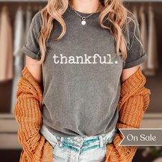 Searching for a minimalist, original, and comfy shirt that will express your overwhelming excitement for Thanksgiving season? Look no further than our "thankful. Comfort Colors Shirt"! This comfortable and stylish shirt is perfect for outdoor activities or relaxing at home. This shirt is sure to keep you cool and comfortable all season long with it's double-needle stitching throughout which makes it highly durable while the lack of side-seams helps the shirt retain its tubular shape.  This origi Everyday Fall Slogan T-shirt, Everyday Cotton T-shirt For Fall, Comfortable Gray Cotton Top, Everyday Soft-washed Comfortable Tops, Everyday Fall T-shirt With Letter Print, Gray Text Print T-shirt For Fall, Relaxed Fit T-shirt For Everyday Fall, Fall Soft-washed Tri-blend T-shirt, Soft-washed Tri-blend Fall T-shirt