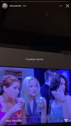 two women and one man standing in front of a tv screen with the words comfort movie on it