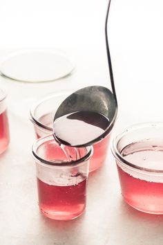 red liquid being poured into small glass containers