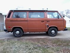 an orange van parked in front of a house