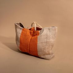 These exceptionally chic oversized totes from Maison Bengal are perfect for days at the beach, picnics in the park, and farmer’s market hauls. They're even roomy enough for a weekend away, with sturdy handles made of woven jute thread. The bags are responsibly produced by women in some of Bangladesh's most marginalized communities, and support a network of more than five thousand women.All bags are handmade so may have slight variations in size and color.Sizing: Length: 23.6" Height: 17.7" Gusse Large Capacity Orange Summer Bag, Large Capacity Orange Bag For Summer, Orange Rectangular Bucket Bag For Summer, Orange Bucket Bag For Summer Travel, Orange Tote Bucket Bag For Summer, Orange Beach Bag With Large Capacity For Shopping, Large Capacity Orange Beach Bag For Everyday Use, Eco-friendly Orange Rectangular Straw Bag, Summer Orange Rectangular Bucket Bag