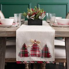 the table is set with christmas decorations and place settings