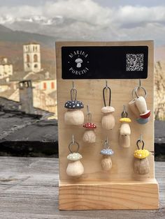 a wooden display with many different types of items hanging from it's hooks and holders