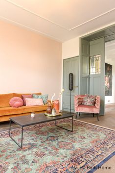 a living room with two couches, a coffee table and a rug on the floor