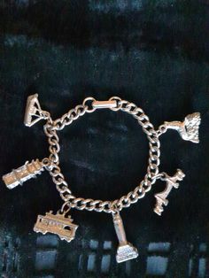 Fantastic Condition.  7 1/2" long with six San Francisco themed charms. Golden Gate Bridge, Tug Boat, China Town Pagoda, Seal sitting on Alcatraz Rock, Coit Tower, Cable Car. Silver tone, weighty, looks never worn. No makers marks. No ware, damage or repairs. 1950's souvenir charm bracelet from San Francisco. Silver Charm Bracelet As Souvenir, Vintage Handmade Metal Charm Bracelet, Vintage Metal Charm Bracelet Handmade, Handmade Vintage Metal Charm Bracelet, Retro Metal Charm Bracelet, Vintage Charm Bracelet As Souvenir, Collectible Vintage Charm Bracelet, Vintage Collectible Charm Bracelet, Handmade Vintage Charm Bracelet Collectible