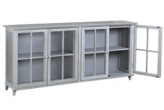 a white bookcase with glass doors on the front and bottom shelves in grey color