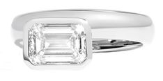 a white gold ring with an emerald cut diamond