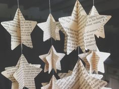 paper stars hanging from strings made out of book pages