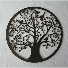 a metal tree with birds sitting on it's branches in a circular shape, hanging from the wall