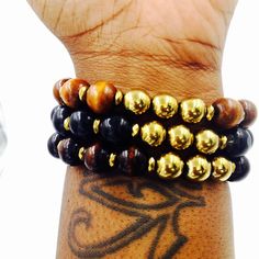 Stylish and Unisex Wood Bracelets 12MM Amber, Ebony or Black Wood Beads 3x6MM Gold Hematite Spacers 10MM Smooth Gold Hematite Gemstones ♦️Perfect for Everyday wear ♦️Perfect as a Gift♦️Average Size 7 3/4 - 8 Inch Gold Bracelets With Wooden Round Beads, Elegant Brown Beaded Bracelets With Black Beads, Ebony Jewelry With Wooden Beads As A Gift, Ebony Jewelry With Wooden Beads For Gifts, Wood And Gold, Amber Lights, Hematite Bracelet, Wood Bracelet, Gold Wood