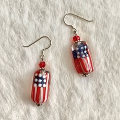 Show Your Patrotic Spirit This Fourth Of July With These Gorgeous Handcrafted Flag Earrings. Hand Blown Murano Glass Beads Paired With Complimenting Faceted Crystal Beads. Each Glass Bead Is Hand Blown With The Utmost Skill And Care, No 2 Beads Are Identical. These High Temperature Glass Beads Are Lightweight Yet Extremely Durable And Beautifully Vibrant In Color. Silver Hardware, Sterling Silver 925 Hook. Red Sterling Silver Beaded Earrings, Adjustable Red Patriotic Earrings, Silver Dangle Patriotic Earrings, Patriotic Silver Dangle Earrings, Red Sterling Silver Beaded Earrings Gift, Patriotic Drop Earrings Jewelry Gift, Patriotic Multicolor Beaded Earrings, Patriotic Dangle Jewelry For Gifts, Nickel-free Red Beaded Sterling Silver Earrings