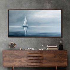 a sailboat floating in the ocean on a cloudy day framed canvas wall art print