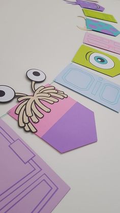 cut out paper shapes with eyes and eyeballs on them, sitting on a table