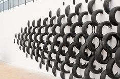 a wall that has some kind of metal design on it, and is next to a white wall