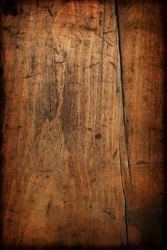 an old wooden surface with peeling paint on it's edges and wood grains