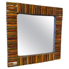 a mirror that is made out of wood and glass with stripes on the edges,