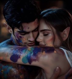 a man and woman hugging each other covered in paint