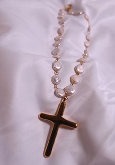 Add a unique twist to your jewelry collection with our Pearl Cross necklace. The 18" Baroque pearl necklace features a playful, irregular stainless steel and 18k gold-plated cross. It's the perfect mix of elegance and edginess! Cross Pendant Necklace With Pearl Drop Gift, Pearl Drop Cross Necklace Gift, Pearl Drop Cross Pendant Necklace For Gift, Pearl Drop Cross Pendant Necklace As Gift, Pearl Charm Cross Necklace For Gift, Pearl Cross Necklace With Pearl Drop As Gift, Gold Cross Necklace With Pearl Charm, Cross Necklace With Pearl Charm For Gifts, Pearl Drop Necklace With Cross Pendant As Gift