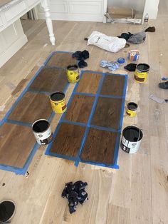 the floor is being painted and ready to be installed with paint buckets on it