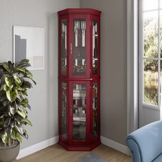 a tall wooden corner cabinet with glass doors